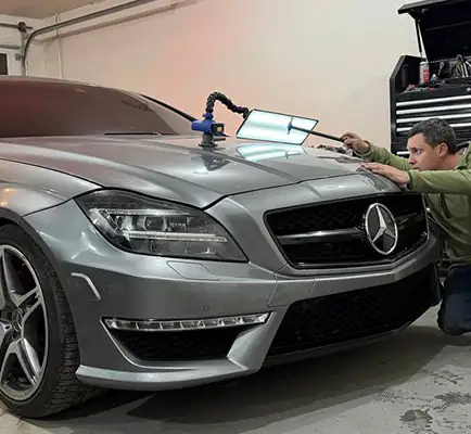 Hail damage repair — car hood covered in hail dents before PDR